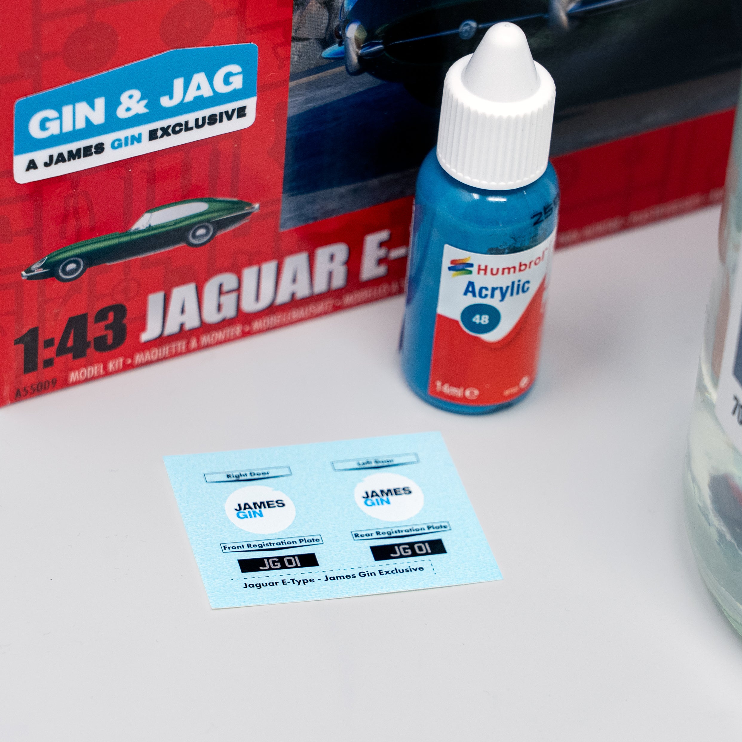 Humbrol acrylic paint bottle with a James Gin & Jag Jaguar E-Type model kit in the background.