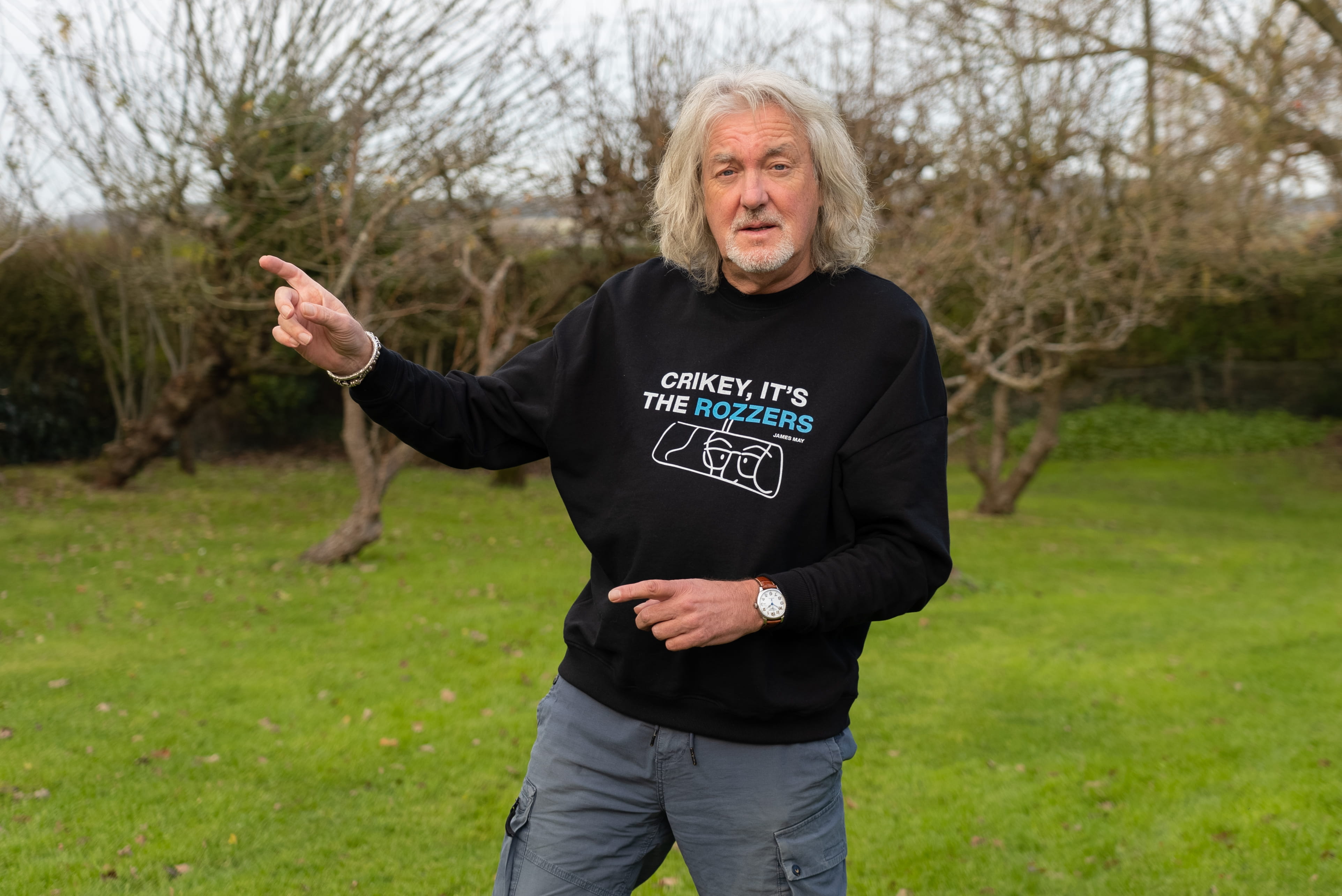 James May wearing his "crikey it's the rozzers" crewneck pointing to the right