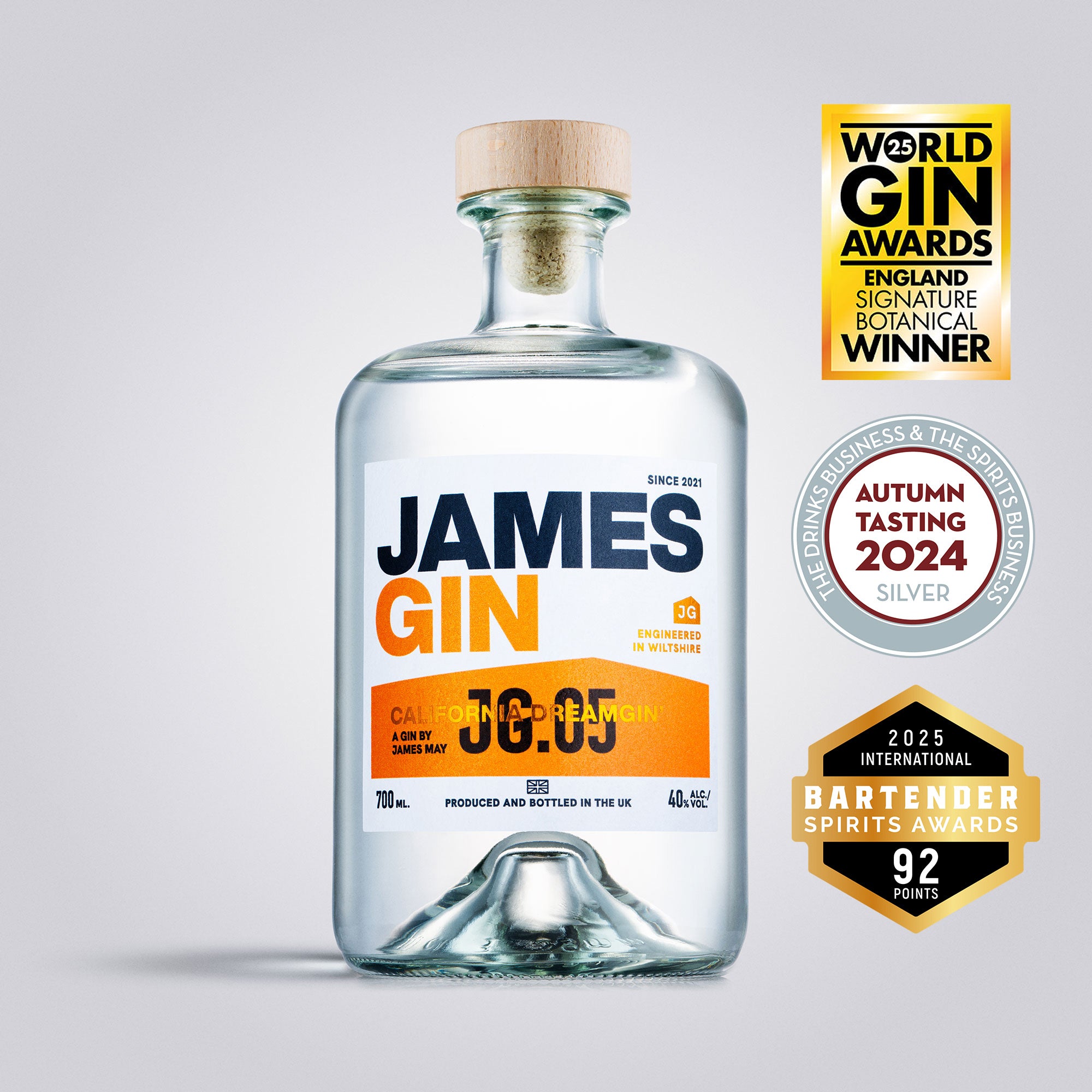 Bottle of James Gin with awards on a light gray background