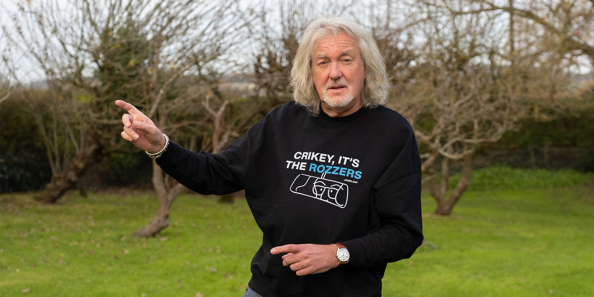 James May wearing his "crikey, it's the rozzers" crewneck pointing to the sky